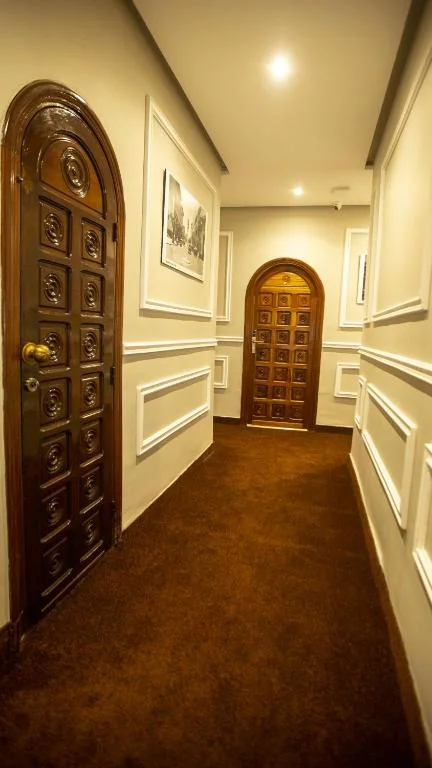 Traditional corridor with arched wooden doors at Hôtel De Paris Casablanca